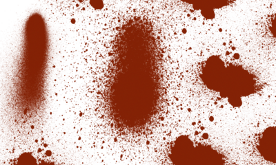 Abstract pattern of brown spray paint splatters on a white background.