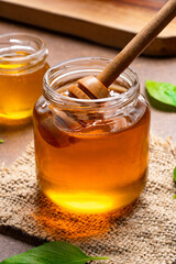 Honey jar and  honey dipper  on vintage background