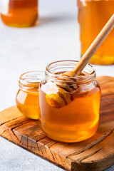 Honey jar and  honey dipper  on vintage background