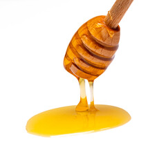 Honey dripping from honey dipper  on white background