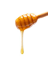 Honey dripping from honey dipper  on white background