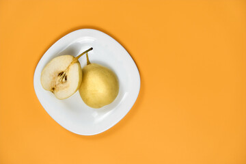 Chinese pear on a white plate. Chinese pear in the section. Chinese pear