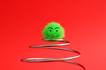 Plush sphere happy to reach the top of a spiral