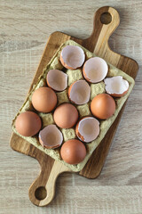 Box of eggs on a wooden board