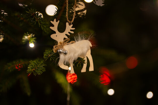 Reindeer Christmas ornament hanging on tree with warm lights