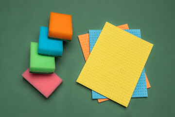 Multicolored cleaning micro fiber cloth and cleaning sponges isolated on yellow background