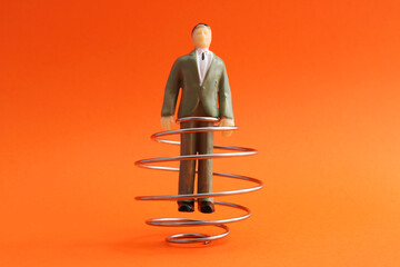 Executive trapped in metal spiral, escaping conflicts