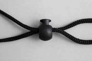 Plastic piece sets a limit and joins two ropes