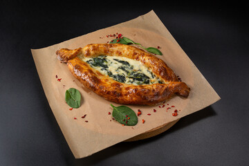 Khachapuri with spinach and cheese is a Georgian dish in the form of an open boat filled with several types of cheese.
