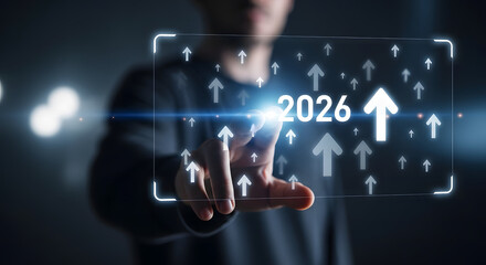 Business person touches futuristic display showing growth arrows and 2026