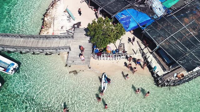 Aerial view of Pulau Kelor Island in Komodo National Park with boats moored near the pier