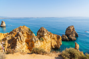 Ponta da Piedade near Lagos in Algarve, Portugal. Tourist boats and cliff rocks in the Atlantic Ocean at Ponta da Piedade, Algarve region, Portugal.