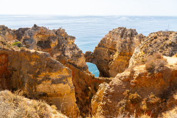 Ponta da Piedade near Lagos in Algarve, Portugal. Tourist boats and cliff rocks in the Atlantic Ocean at Ponta da Piedade, Algarve region, Portugal.