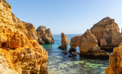 Naklejka premium Ponta da Piedade near Lagos in Algarve, Portugal. Tourist boats and cliff rocks in the Atlantic Ocean at Ponta da Piedade, Algarve region, Portugal.