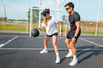 Training session with a workout coach and a female athlete in outdoor sports facility