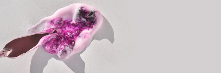 Melted pink lipstick and purple crystals on light gray background with shadows.