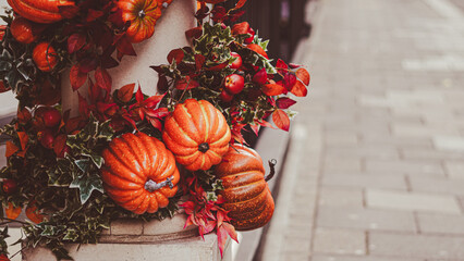 Rustic fall doorway with pumpkins and natural harvest accents.