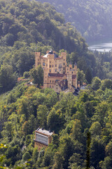 Views of Hohenschwangau castle surrounded by lush greenery in the German Alps