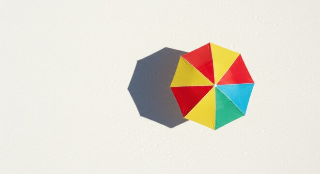 Colorful Beach Umbrella's Shadow on Textured White Surface, Overhead View