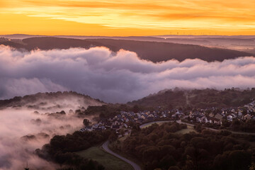 Stunning sunrise over the Rhine River near Bad Salzig, Germany, showcasing layered clouds and peaceful valleys