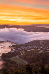 Stunning sunrise over the Rhine River in Bad Salzig, Germany with misty valley and glowing sky