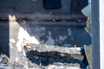 Charred remains of a building after a fire in an urban area during daylight hours