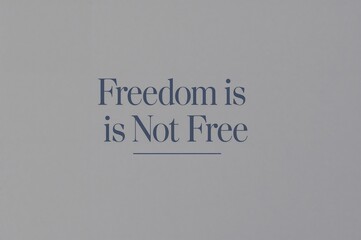 Typographic message 'Freedom is not Free' in a classic serif font on a minimalist grey background, a powerful reminder of sacrifice and liberty