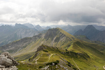 Stunning view of Nebelhorn peaks surrounded by clouds in the German Alps during summer hike