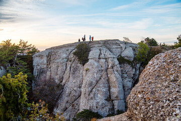 Rocks in the Demerdzhi mountain range on the background of sunset. Landscape, sights of Russia, sea, mountains.
