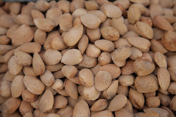 Almonds in shell making healthy food background texture