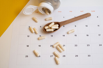 Dosage of pills by day, medication calendar, pill organizer with copy space.