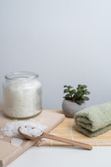 Close-up of magnesium salt flakes. Spa body care and magnesium therapy. White salt, cotton towels, eco-friendly products for home relaxation spa.
