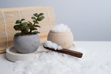 Close-up of magnesium salt flakes. Spa body care and magnesium therapy. White salt, cotton towels, eco-friendly products for home relaxation spa.
