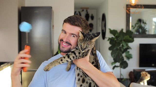 Man taking a video selfie with his gorgeous cat