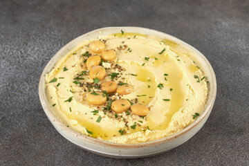 Lupini bean hummus with olive oil, herbs and pita bread on dark background. Vegetarian food.