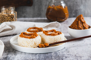 Spicy rice donuts with miso paste on a plate on the table