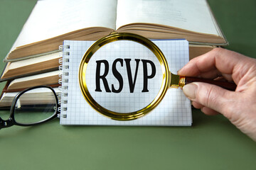 A woman's hand holds a magnifying glass over the word RSVP on a green background with books