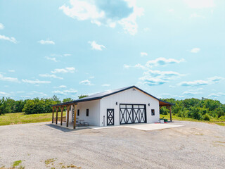 White barn in a gravel area © Chris