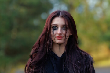 Naklejka premium Cinematic Portrait with Smeared Makeup in Autumn