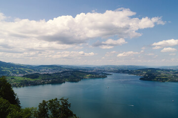 Hiker's Reward View: Images that make the viewer feel like they have reached a high summit. Spectacular, rewarding views over lakes or valleys, perfect for outdoor and fitness promotion.