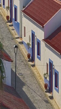  Aerial view of small village with windmill and picturesque rooftops, Odeceixe, Portugal