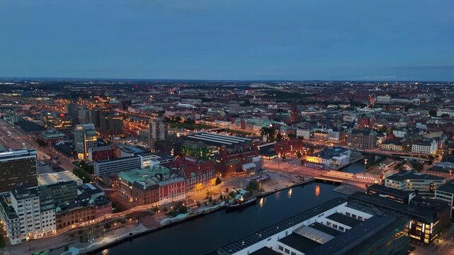 Soft shadows fall across V&auml;stra Hamnen&rsquo;s boardwalk and buildings