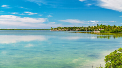 Serene seascape with palm-covered island and calm blue ocean