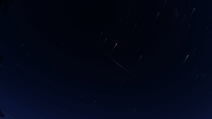 Star trails in night sky with Orionid meteor - time exposure
