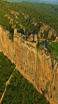  Mornas Fortress stands majestically on top of a rocky cliff. The Fortress of Mornas is a medieval fortress above the village of the same name in the French department of Vaucluse