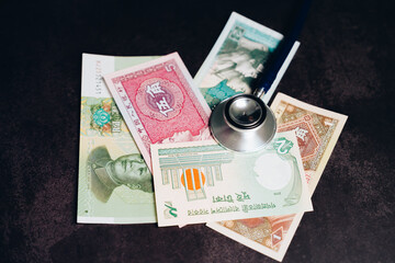 Stethoscope on Mixed Currency Banknotes Suggesting Financial Health and Economic Stability in Global Markets