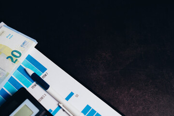 Financial Planning Tools with Currency Notes, Graphs, and Instruments on a Dark Background for Professional Use