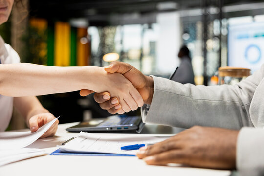 Close up of handshake between a professional applicant and hiring manager, confirming a job approval and career opportunity in corporate space. Smooth head hunting and recruitment process.