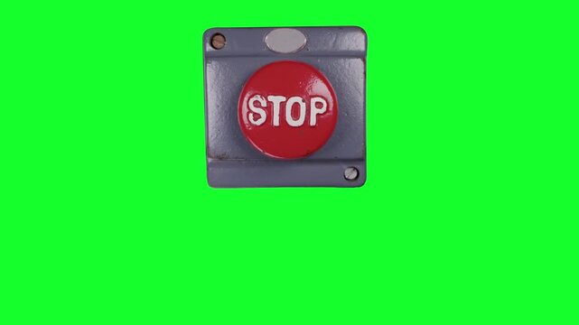 hand pressing an industrial stop button green screen