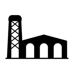 Silhouette of industrial building with a water tower and arched windows